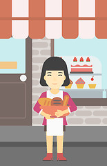 Image showing Baker holding basket with bakery products.