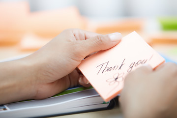 Image showing Businesswoman holdings sticky note with Thank you text