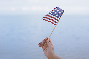 Image showing Woman waving US flag