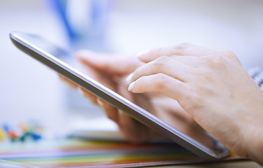 Image showing Woman using digital tablet at office