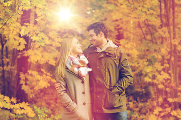 Image showing smiling couple hugging in autumn park