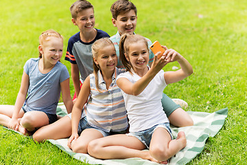 Image showing happy kids or friends taking selfie in summer park