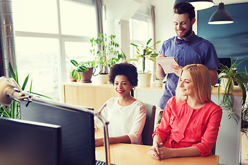 Image showing happy creative team with computer in office