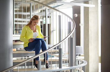 Image showing smiling high school student girl reading book