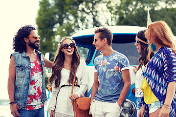 Image showing smiling young hippie friends over minivan car