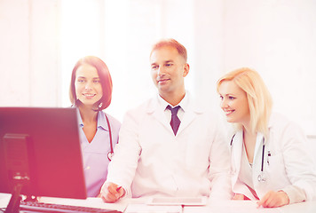 Image showing doctors looking at computer on meeting