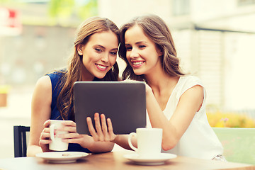 Image showing young women with tablet pc and coffee at cafe