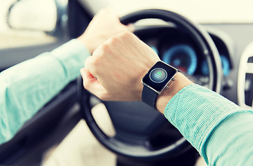 Image showing hands with starter icon on smartwatch driving car