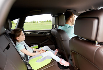 Image showing family with child in safety seat driving car