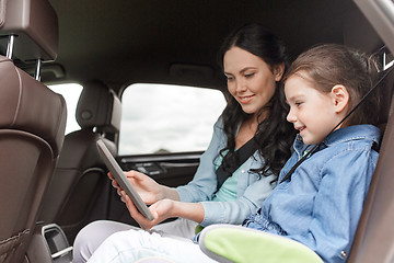 Image showing happy family with tablet pc driving in car