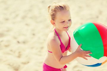 Image showing happy little girl playing inflatable ball on beach