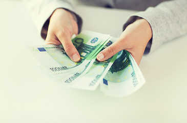 Image showing close up of woman hands counting euro money