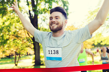 Image showing happy young male runner winning on race finish