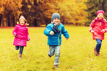 Image showing group of happy little kids running outdoors