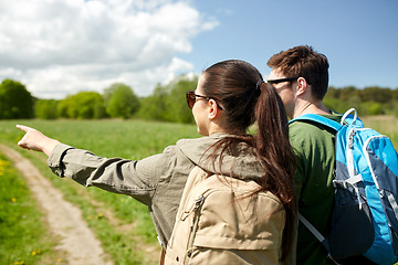 Image showing happy couple with backpacks hiking outdoors