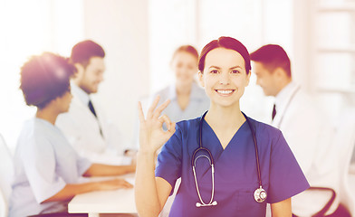 Image showing happy doctor over group of medics at hospital