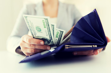 Image showing close up of woman hands with wallet and money