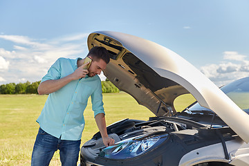 Image showing man with broken car calling on smartphone