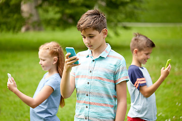 Image showing kids with smartphones playing game in summer park