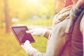 Image showing couple hands in gloves with tablet pc outdoors