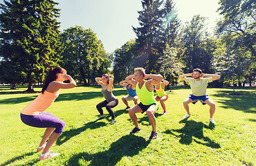 Image showing group of happy friends exercising outdoors
