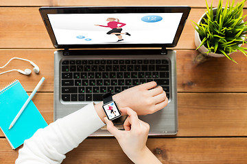 Image showing close up of woman with smart watch and laptop