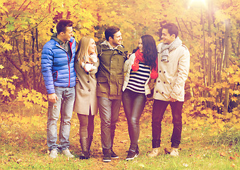 Image showing group of smiling men and women in autumn park