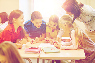 Image showing group of school kids writing test in classroom