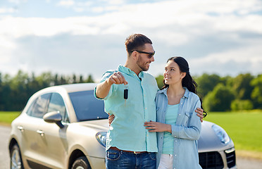 Image showing happy man and woman with car key hugging 