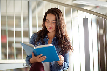 Image showing high school student girl reading book at library