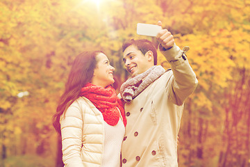 Image showing smiling couple hugging in autumn park