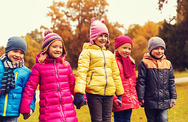 Image showing happy children holding hands in autumn park