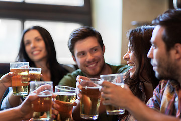 Image showing happy friends drinking beer at bar or pub