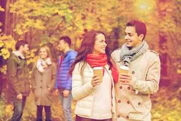 Image showing group of smiling friend with coffee cups in park