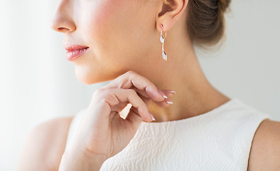 Image showing close up of beautiful woman face with gold earring