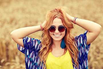 Image showing smiling young redhead hippie woman outdoors