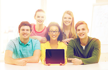 Image showing smiling students showing tablet pc blank screen