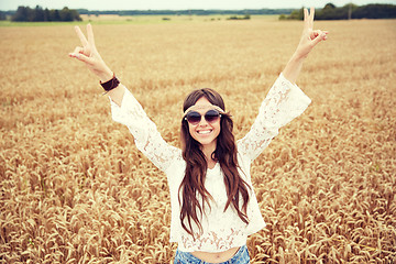 Image showing smiling young hippie woman on cereal field