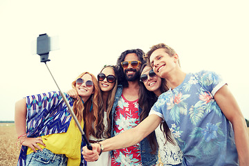 Image showing hippie friends with smartphone on selfie stick