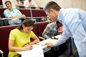 Image showing group of students and teacher with notebook