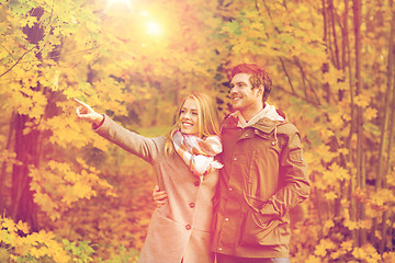 Image showing smiling couple hugging in autumn park