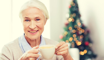 Image showing happy senior woman with cup of coffee at home