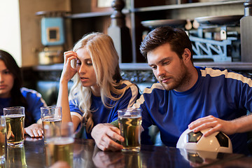 Image showing football fans or friends with beer at sport bar