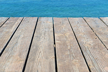 Image showing Empty top of wooden background and view to the sea