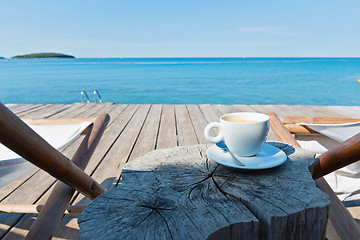 Image showing Wooden floor with chaise-longues and coffee