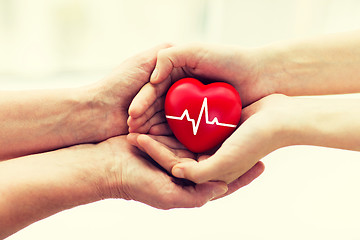 Image showing man hand giving red heart to woman