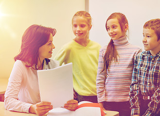 Image showing group of school kids with teacher in classroom