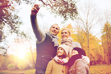 Image showing happy family with camera in autumn  park