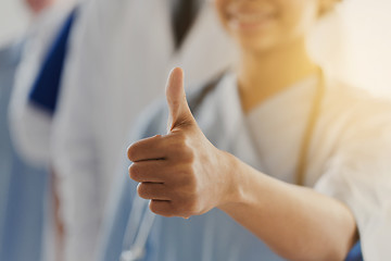 Image showing close up of doctor or nurse showing thumbs 