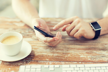 Image showing close up of hands with smart phone and watch